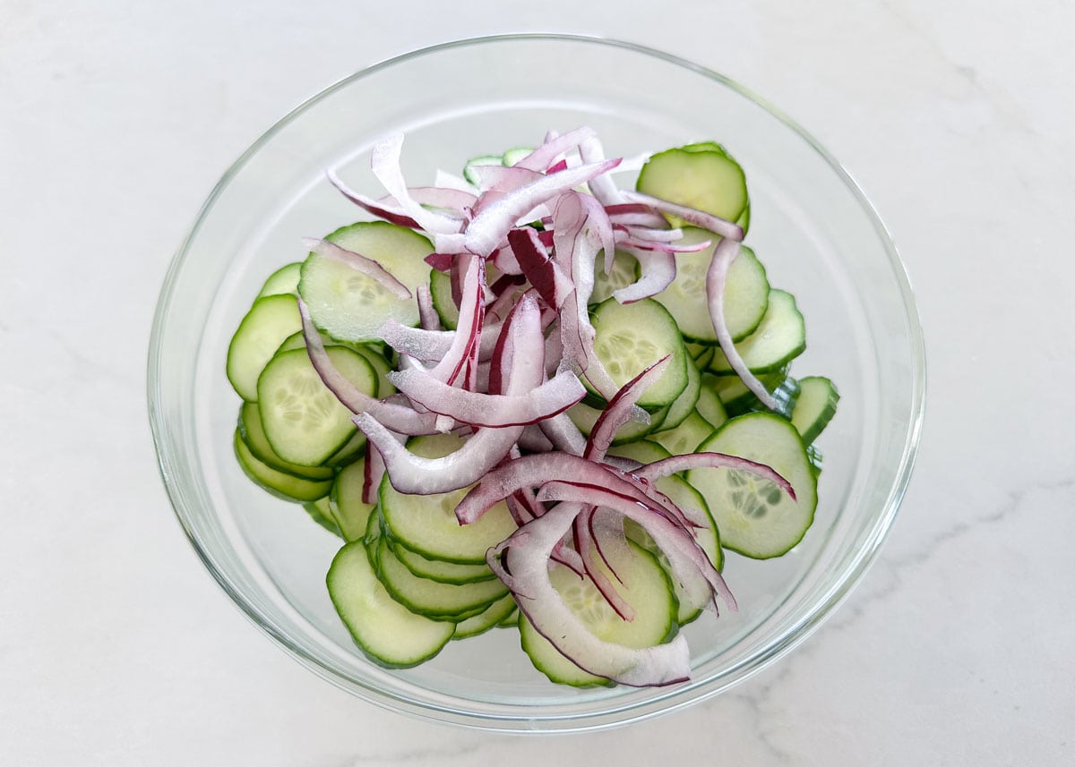 Cucumbers and onions in a bowl.