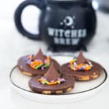 Witch hat cookies on a plate.