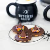 Witch hat cookies on a plate.