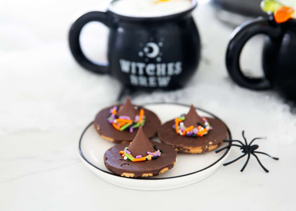 Witch hat cookies on a plate.