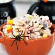 Halloween Chex mix in a pumpkin bowl.