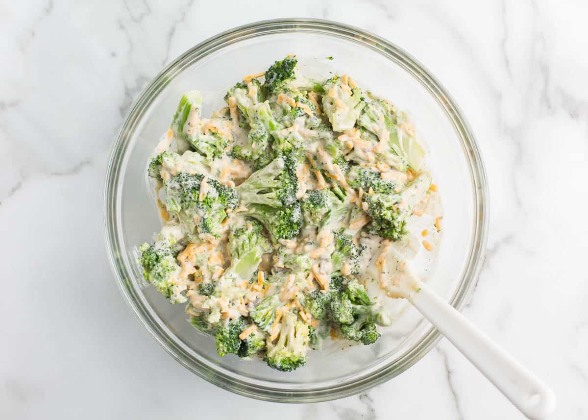 Showing how to make broccoli cheese casserole.