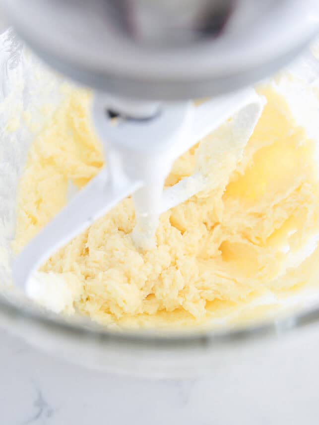 Butter and sugar creamed in bowl of a stand mixer.