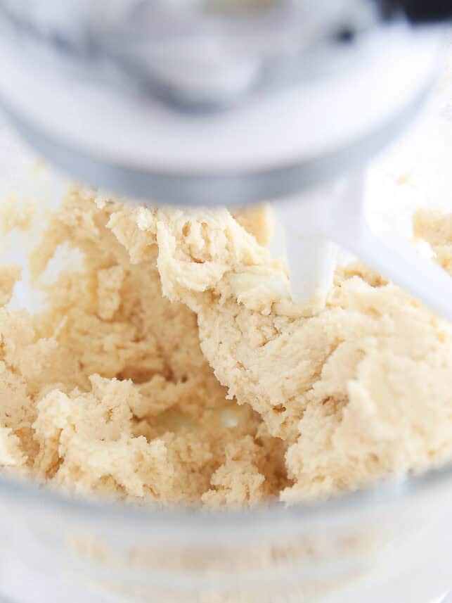 Butter cookie dough in stand mixer.