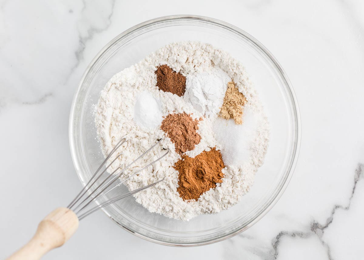 Whisking flour in a bowl.