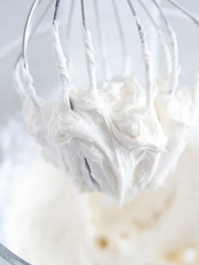 Vanilla frosting on a whisk.