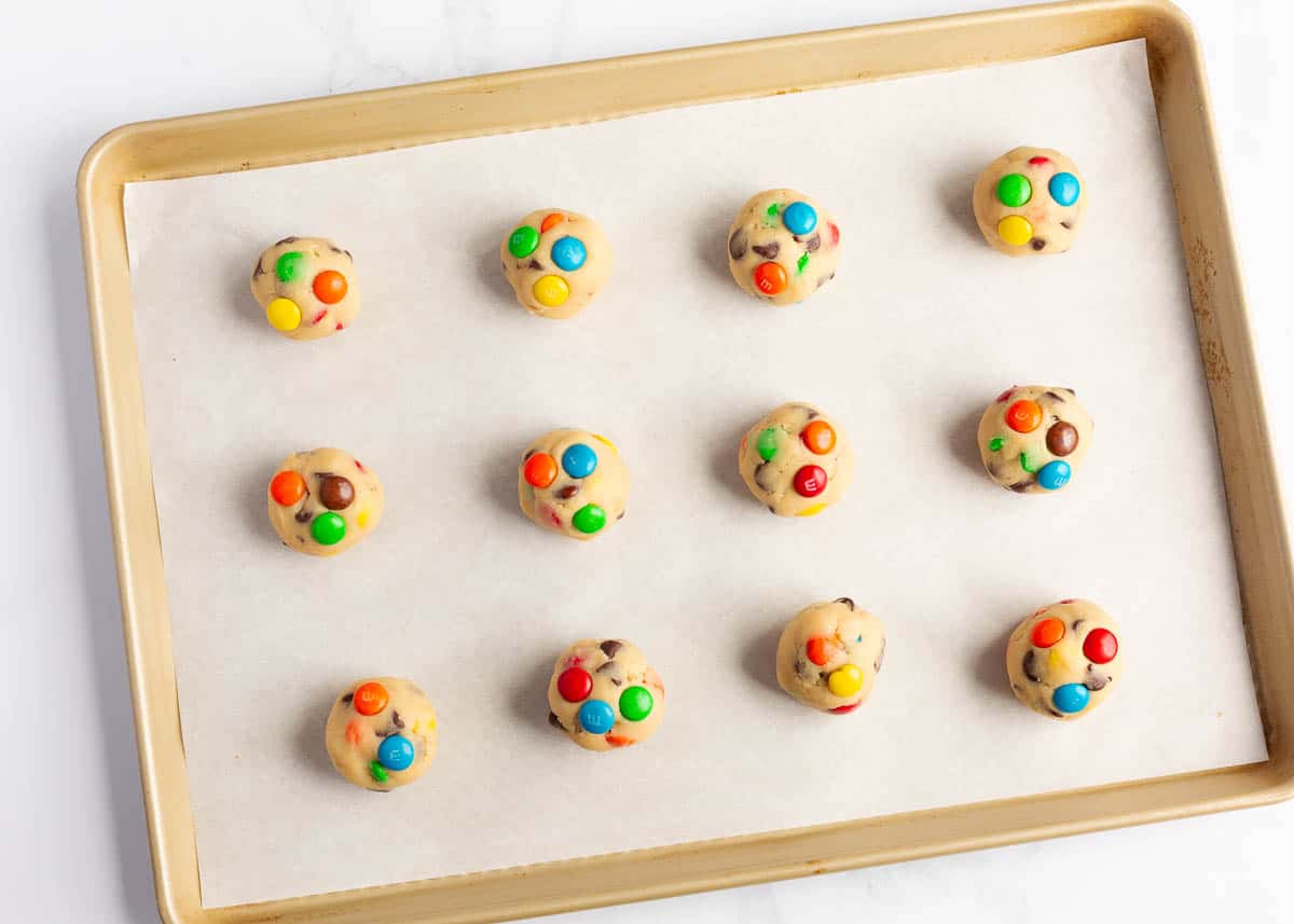 M&M cookie dough balls on the counter.