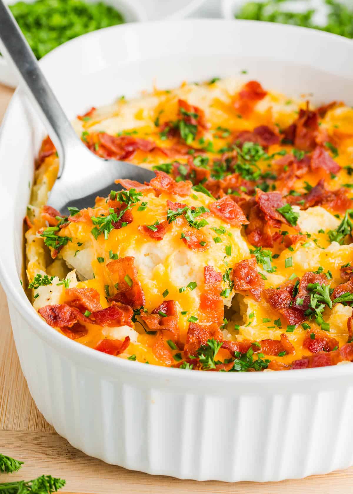 Mashed potato casserole with bacon on top.