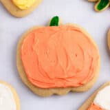 Pumpkin cut-out cookies on counter.