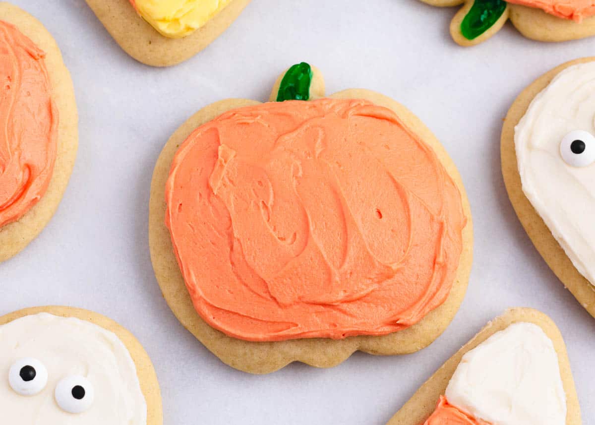 Pumpkin cut-out cookies on counter.