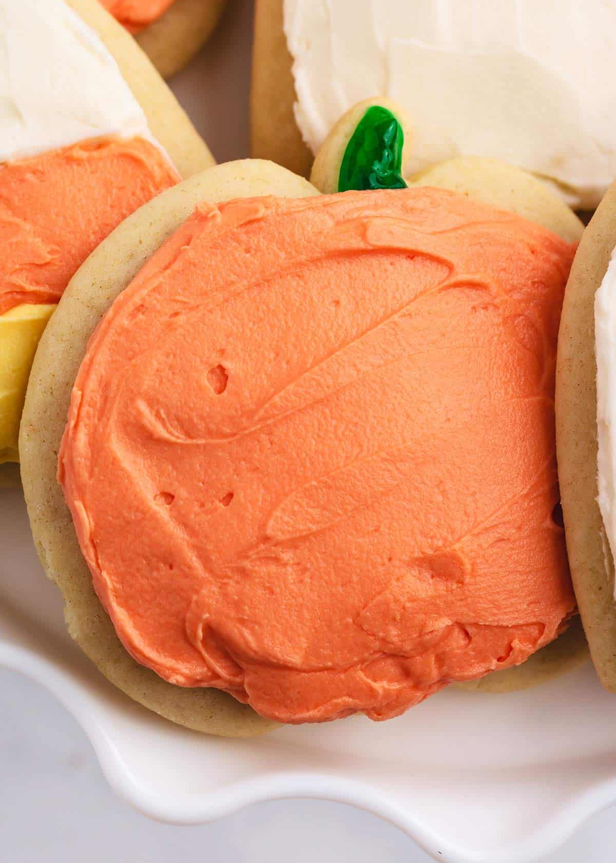 Pumpkin cut-out cookies on cake plate.