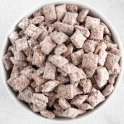 Puppy chow in a white bowl.