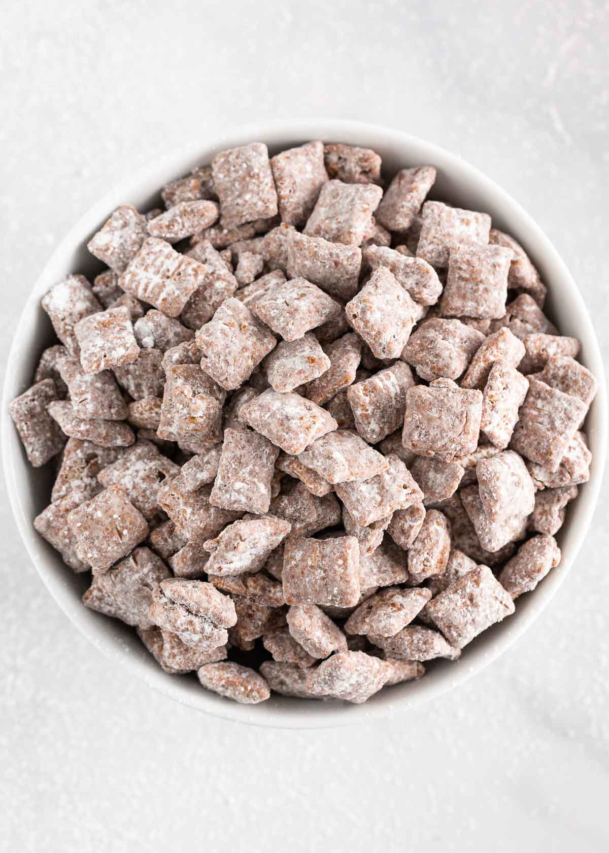 Puppy chow in a white bowl.