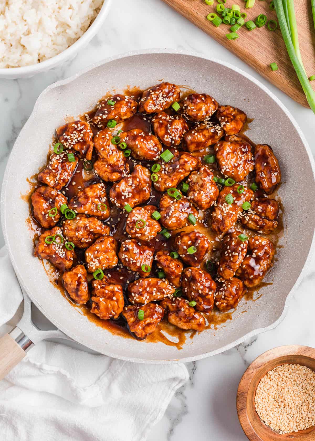 Sesame chicken in a pan.