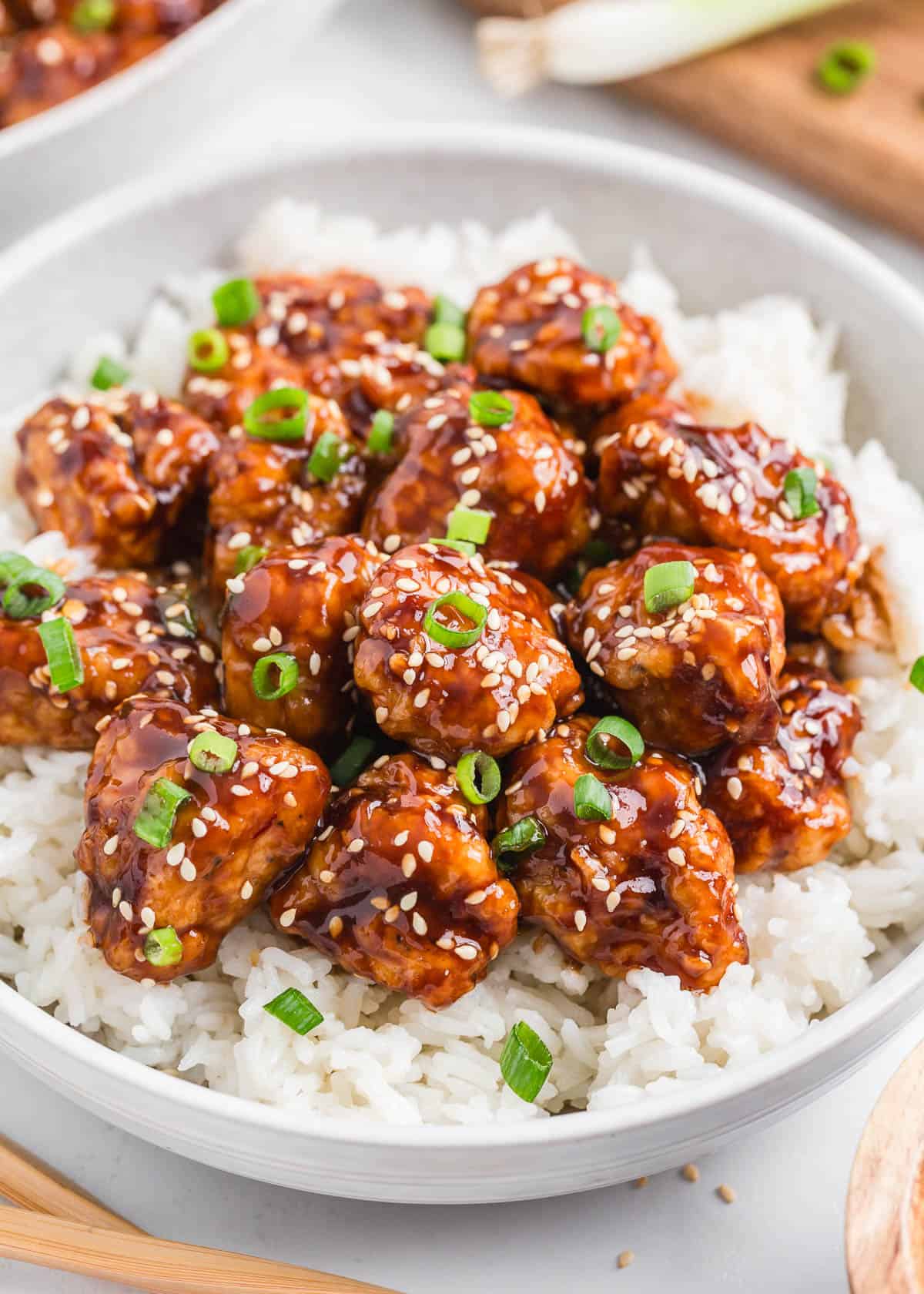 Sesame chicken and rice in a bowl.