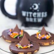 Witch hat cookies on a plate.