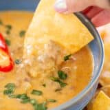 Dipping chip in cottage cheese queso.