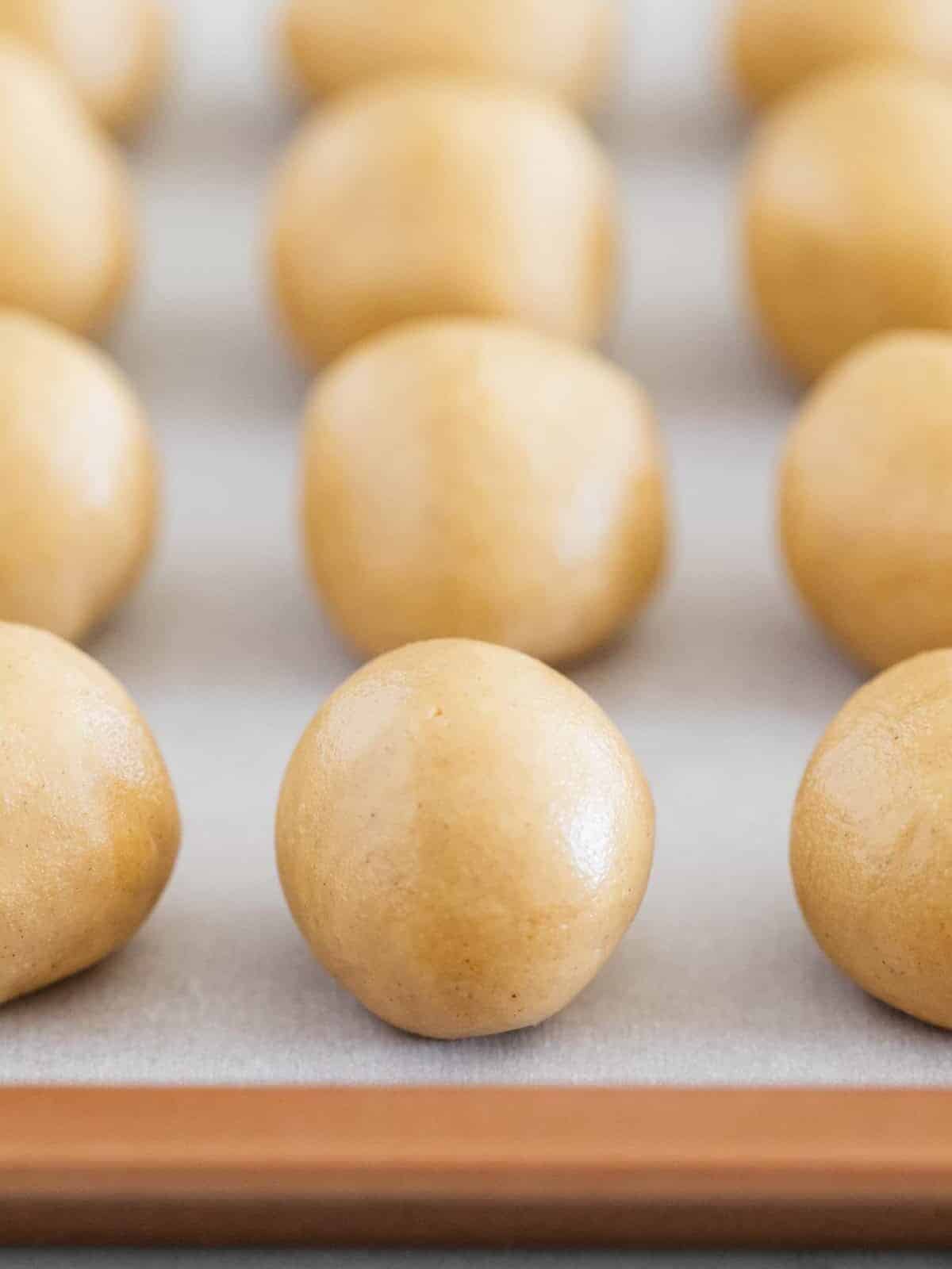 Buckeyes on parchment paper lined cooking sheet.