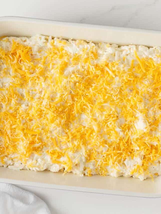 Assembled unbaked hash brown casserole.