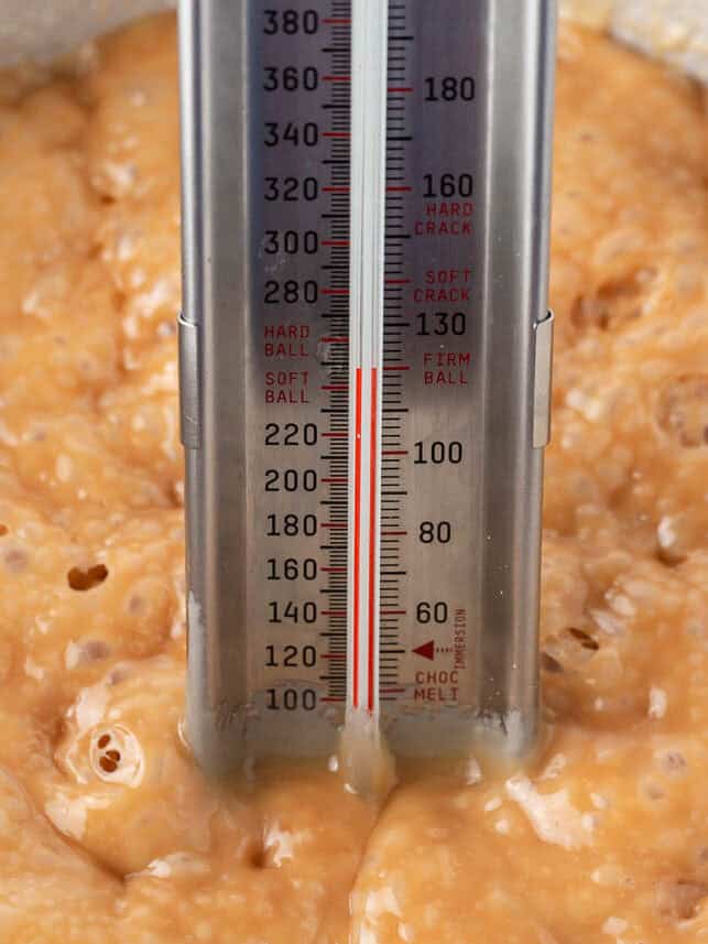 Check the temperature of caramel with a candy thermometer.