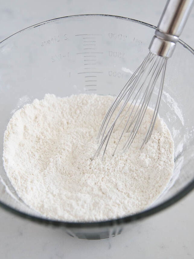 Flour, sugar, salt and baking powder in a bowl.