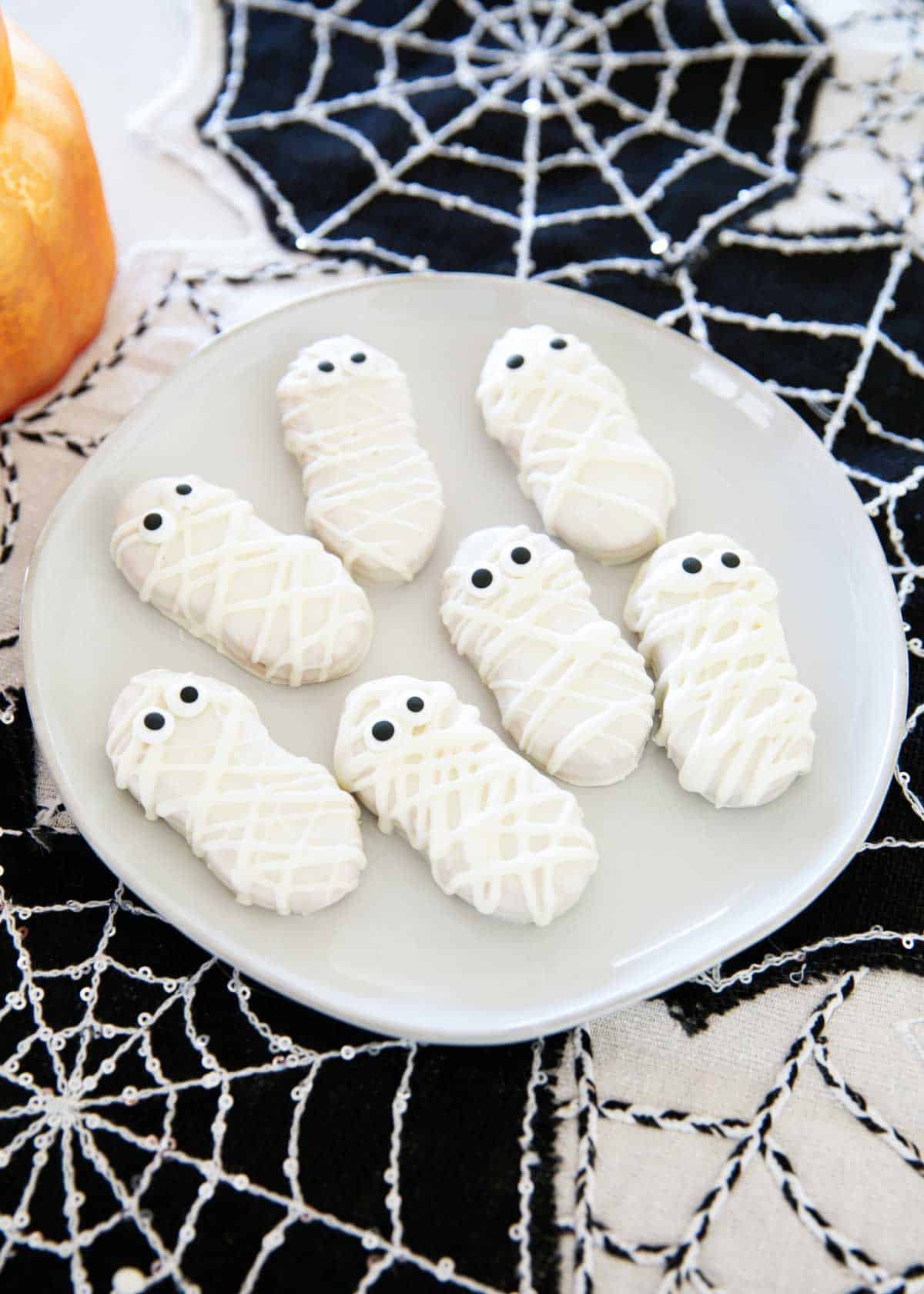 Mummy cookies on a plate.