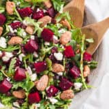 Beet salad with tongs.