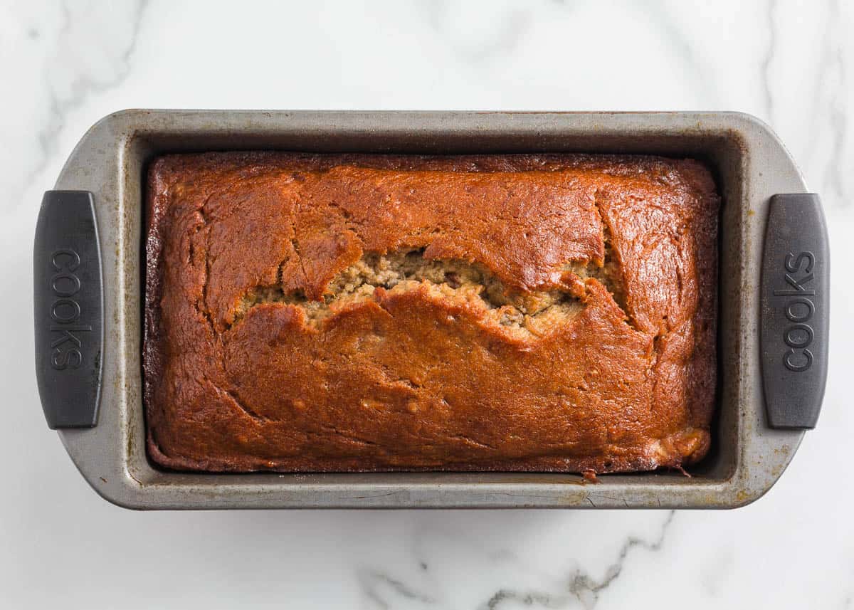 Cinnamon roll banana bread baked in a loaf pan.