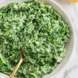 Creamed spinach in a white bowl.