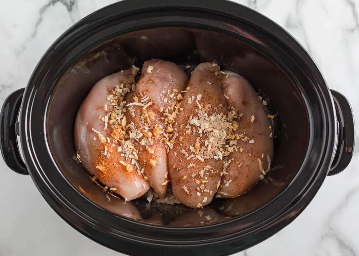 Showing how to make crockpot chicken and potatoes.