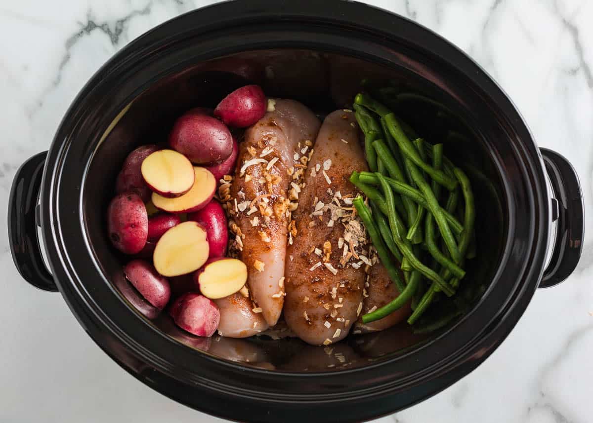 Showing how to make crockpot chicken and potatoes.