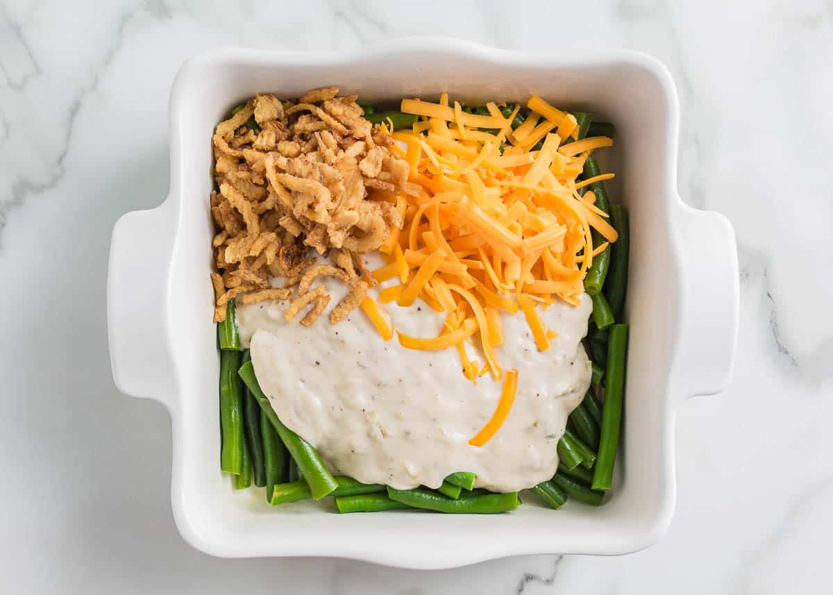 Showing how to make green bean casserole.