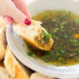 Dipping bread into bread dipping oil.