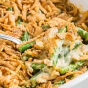 Green bean casserole with fresh green beans made in a casserole dish.