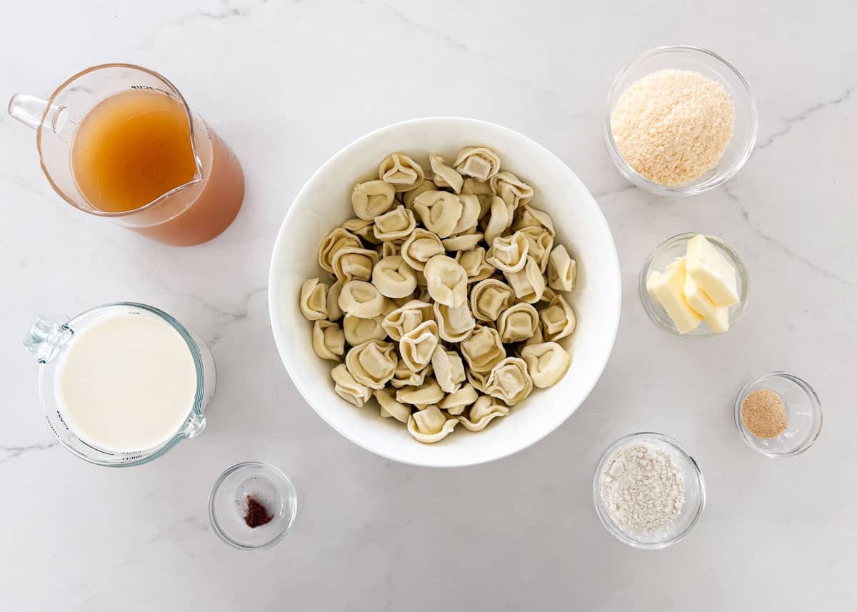 Chicken tortellini alfredo ingredients on the counter.