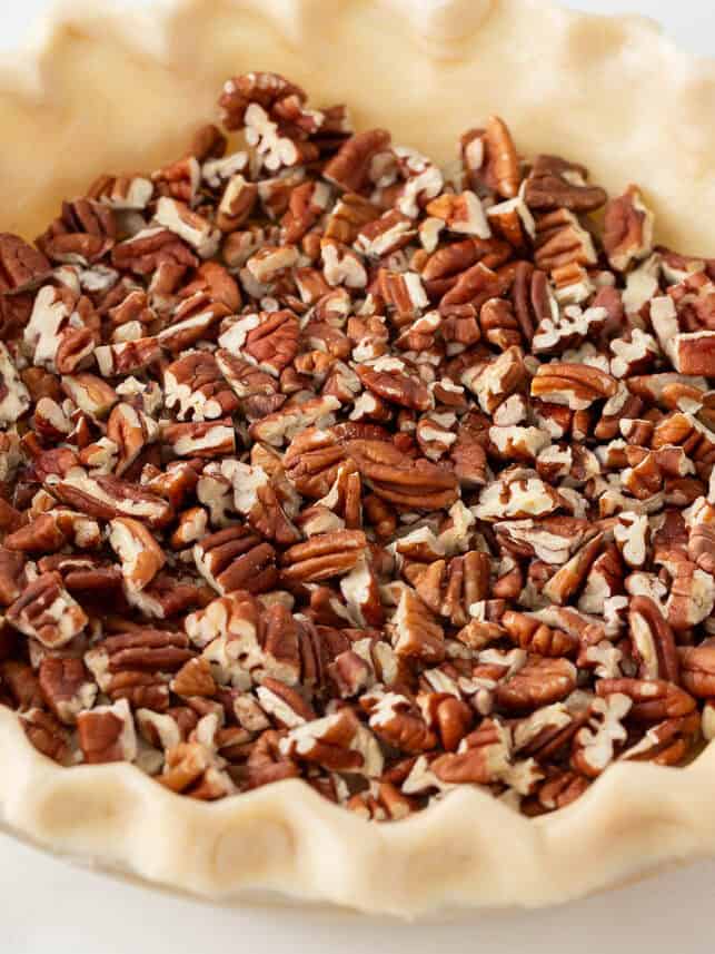 Chopped pecans in pie crust.