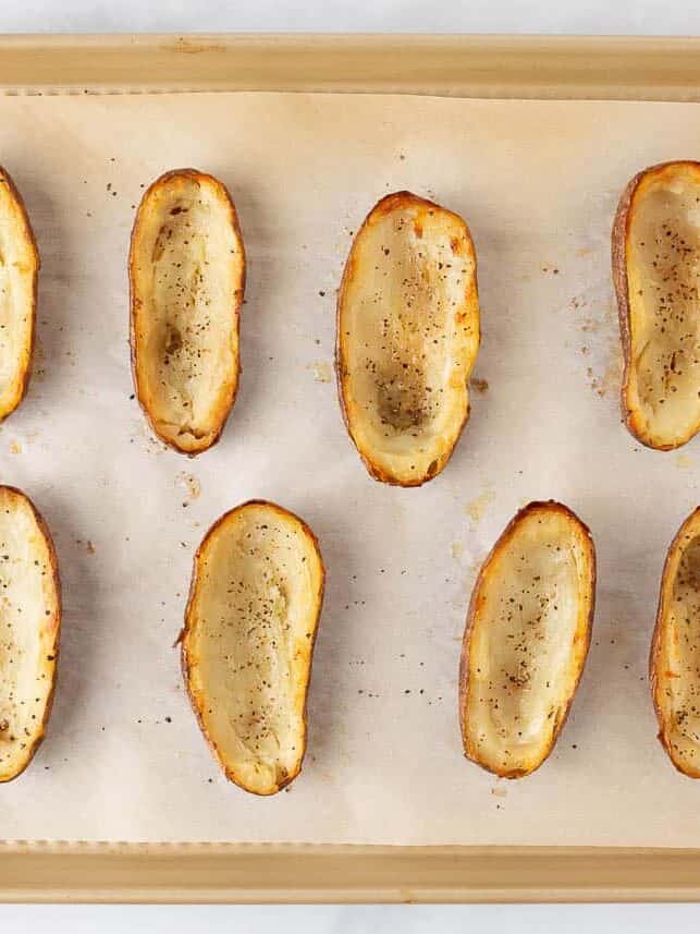 Potato shells on a baking sheet.