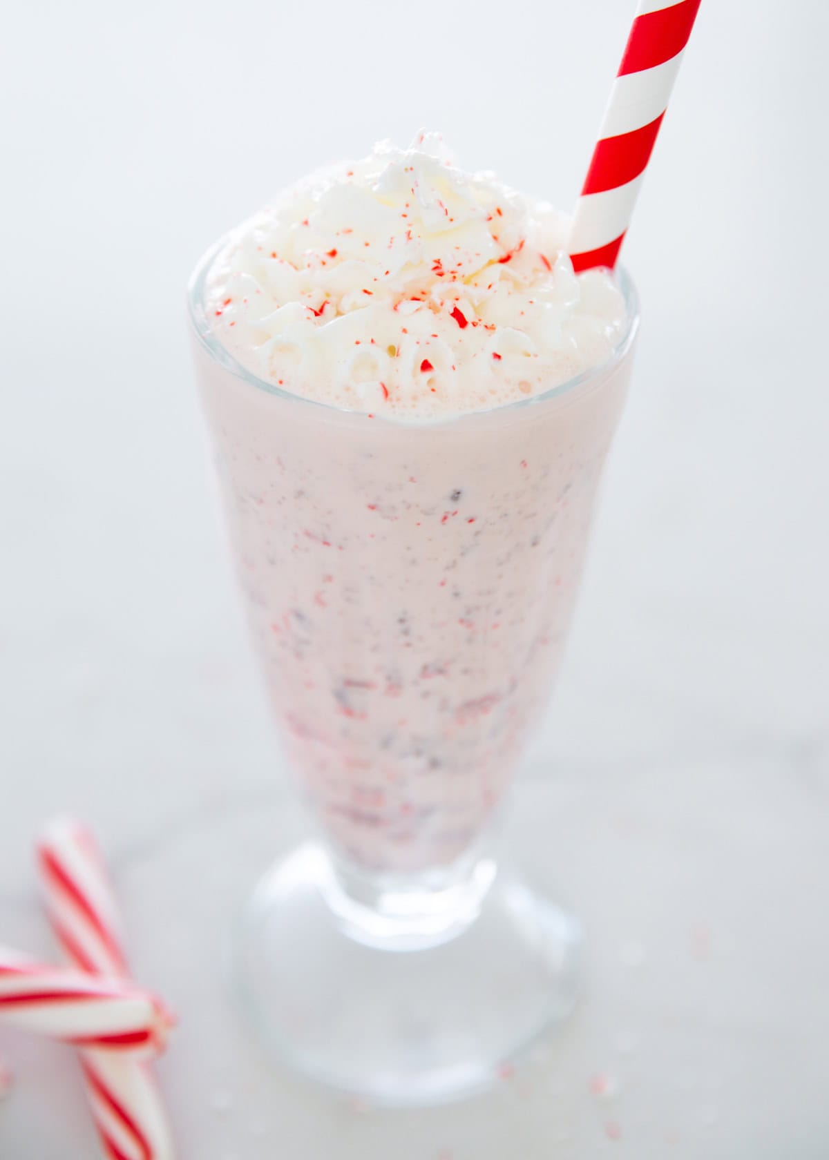 Peppermint milkshake in a glass cup.