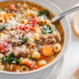 Italian sausage soup in a bowl garnished with Parmesan.