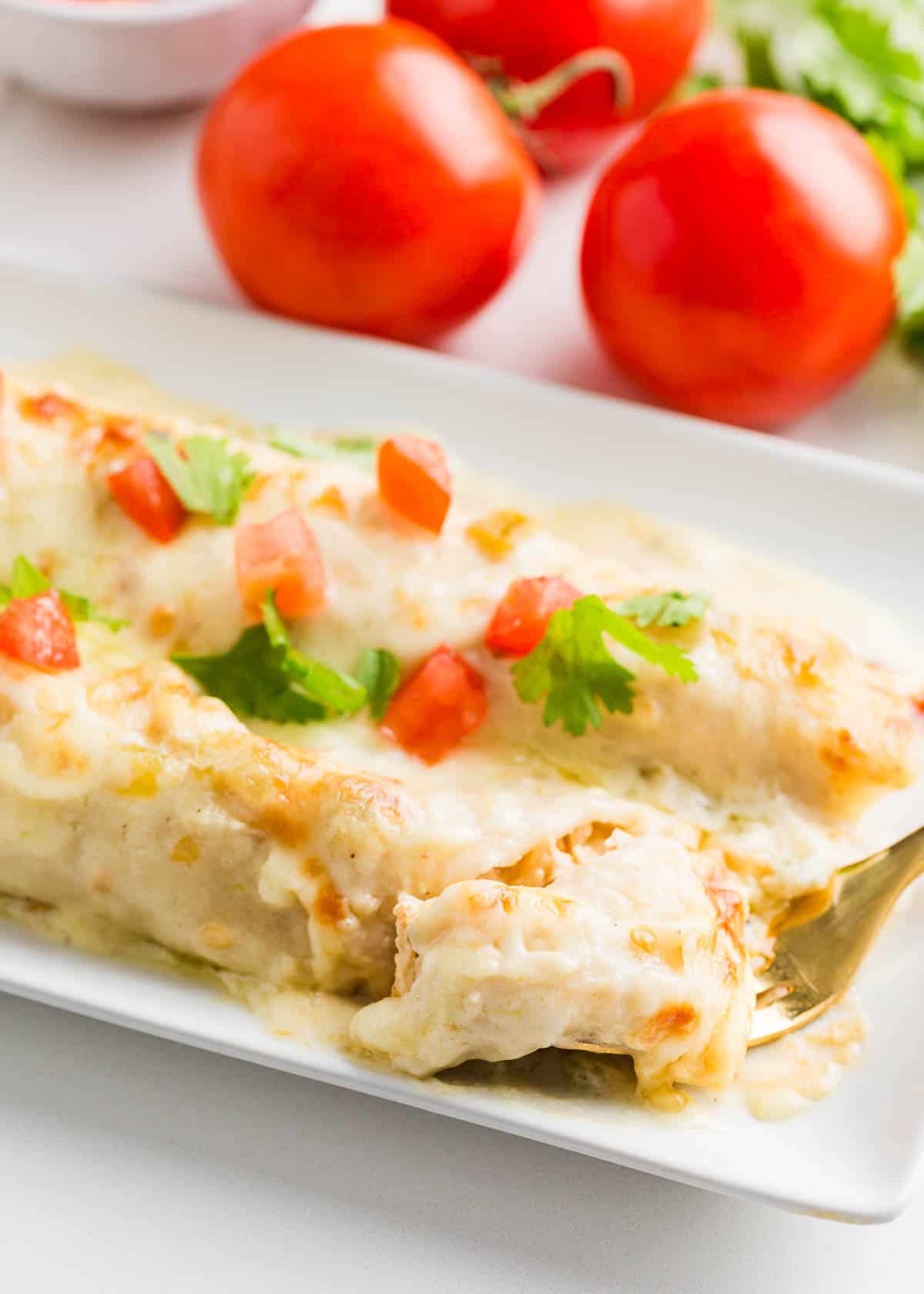 White chicken enchiladas on a plate.