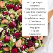 Beet salad with arugula and balsamic dressing in a bowl with ingredients listed.