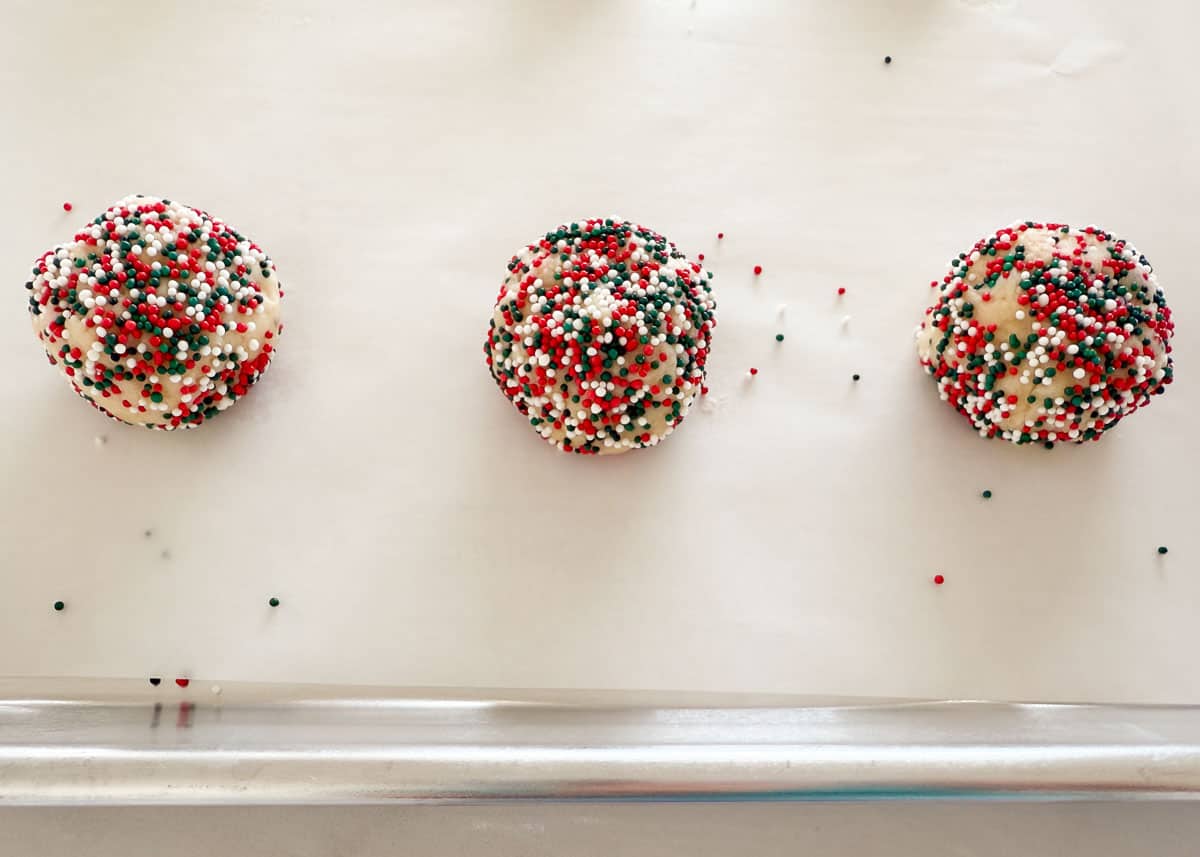 Cookie dough balls on baking sheet.