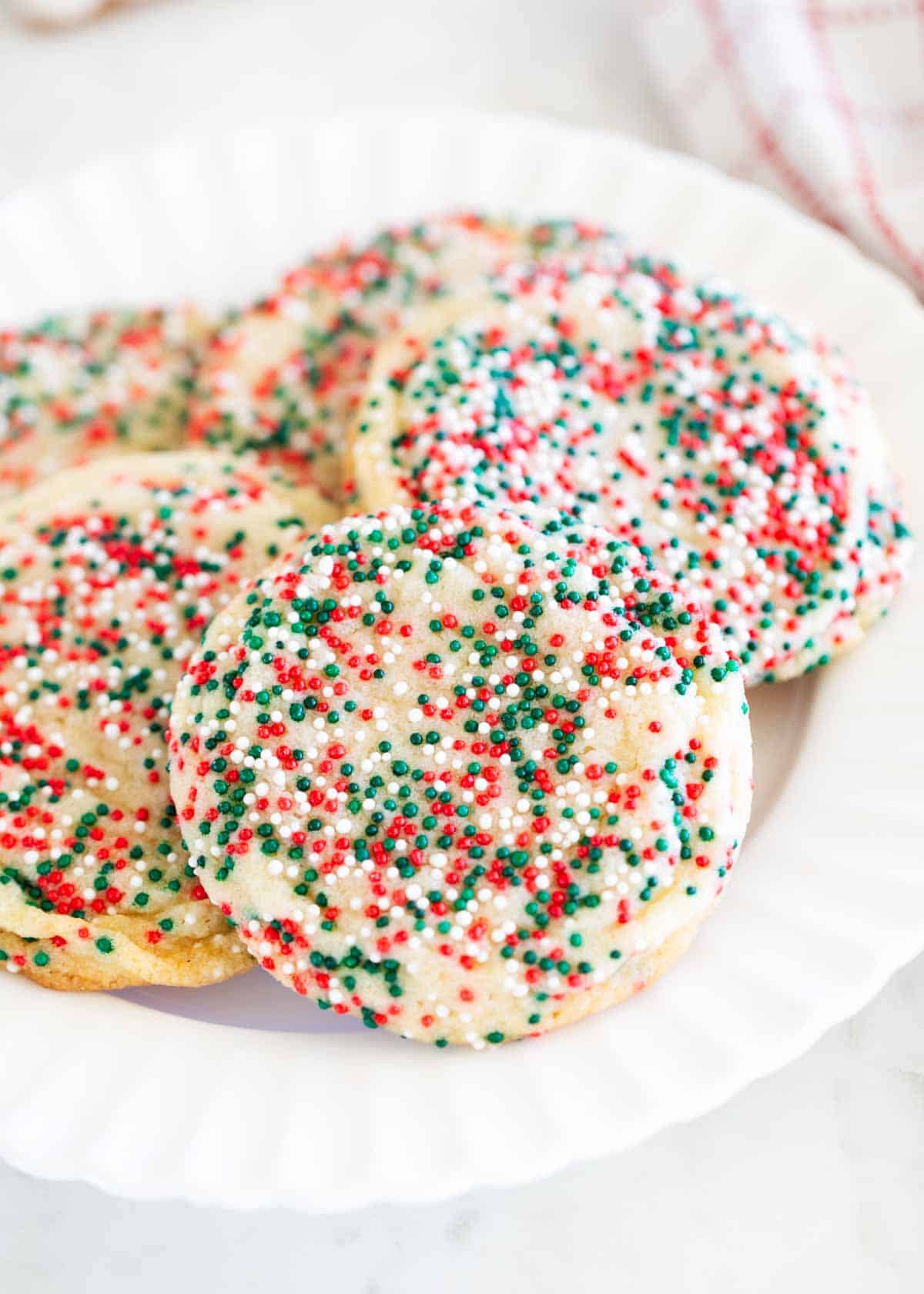 Drop sugar cookies on a white plate.