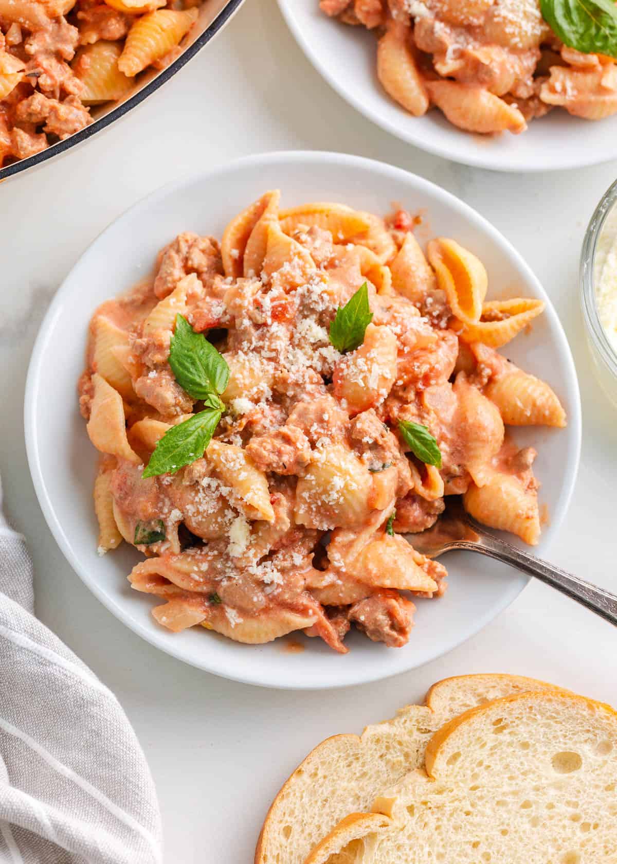 Shell pasta with ground turkey on a white plate.