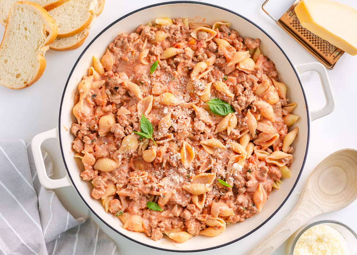 Easy ground turkey pasta with shells in a white skillet.