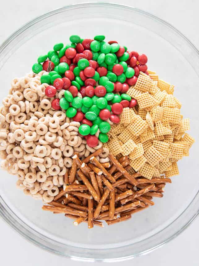 Cheerios, M&Ms, Chex and pretzels in a bowl.