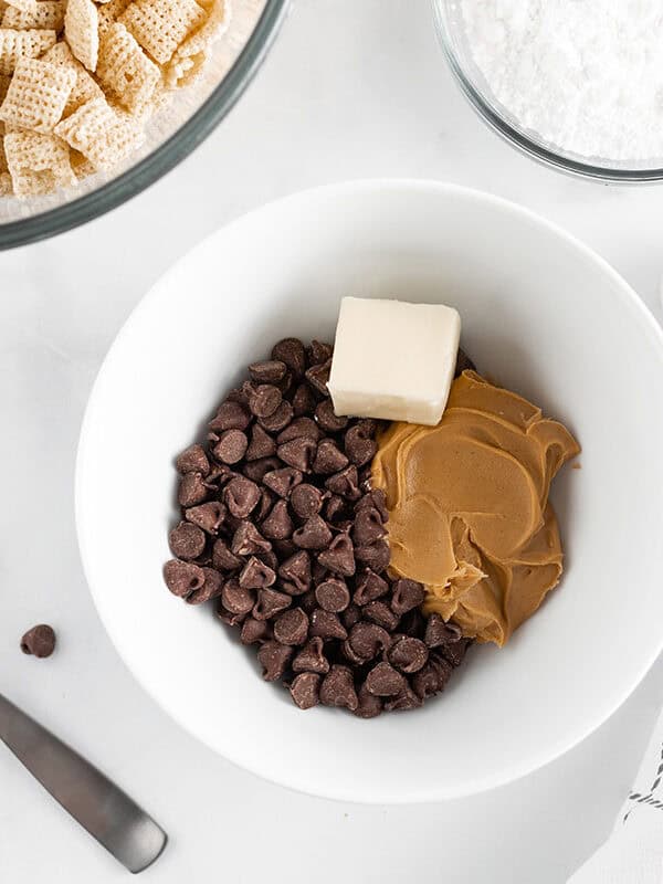 Chocolate chips, peanut butter and butter in a bowl. 