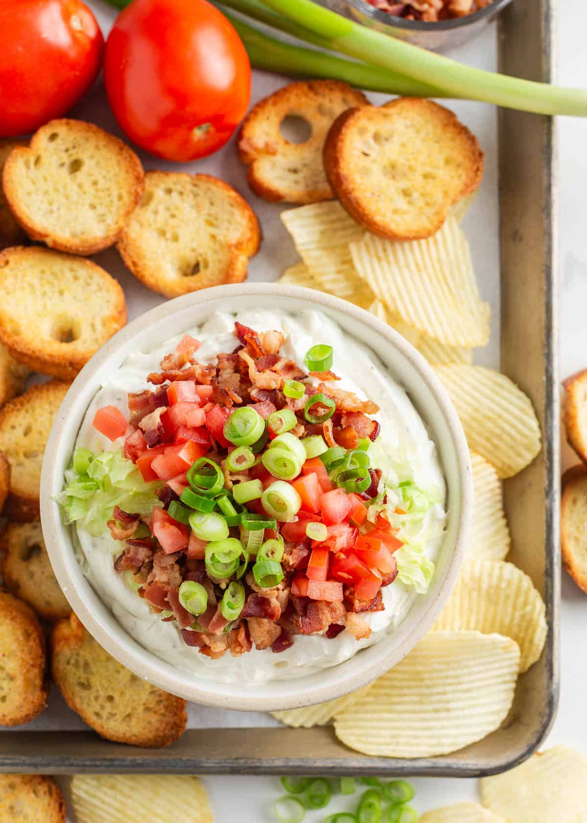 BLT dip in a bowl on a platter for serving.