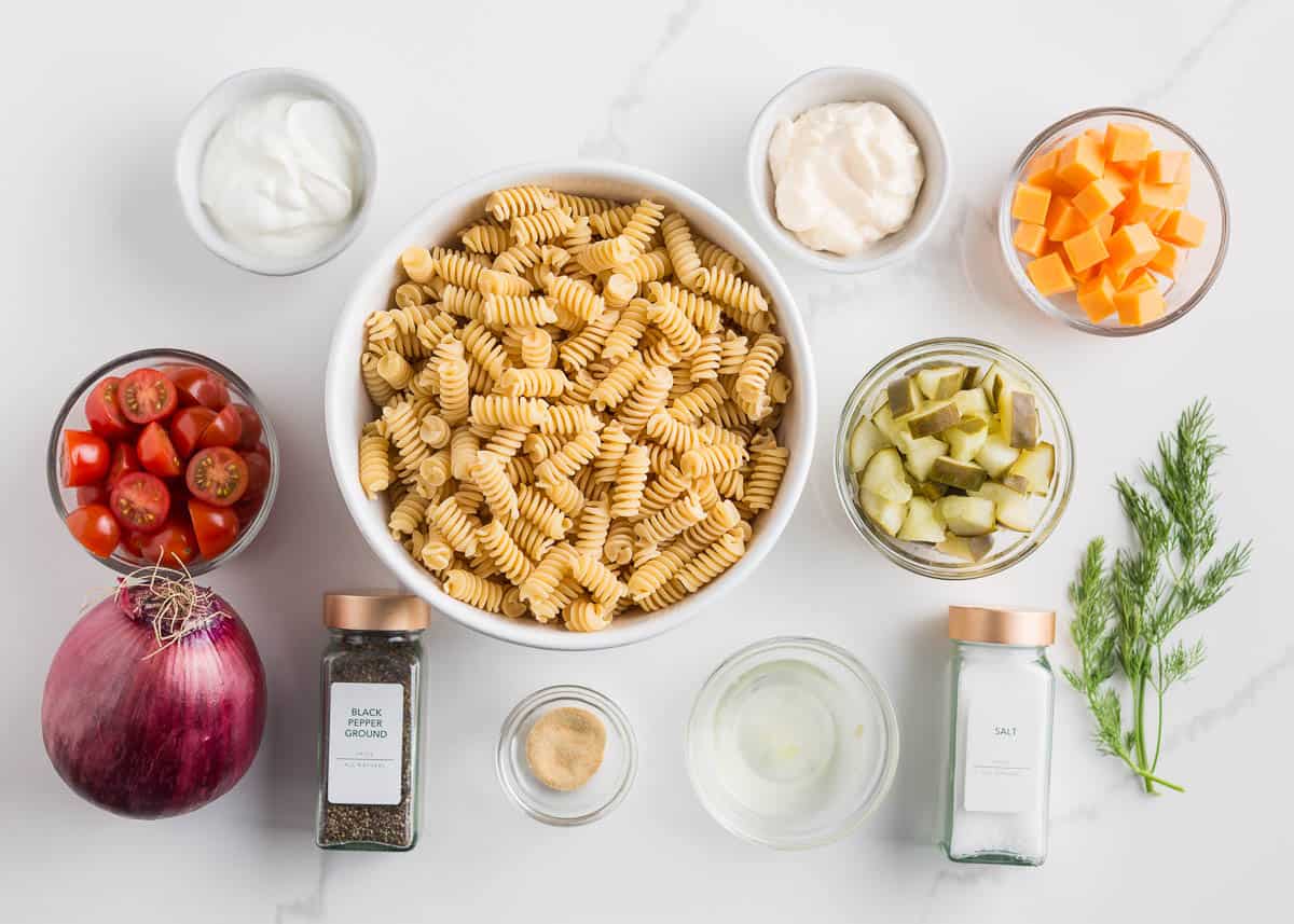 Dill pickle pasta salad ingredients on the counter.