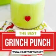 Grinch punch in a glass with festive straw.